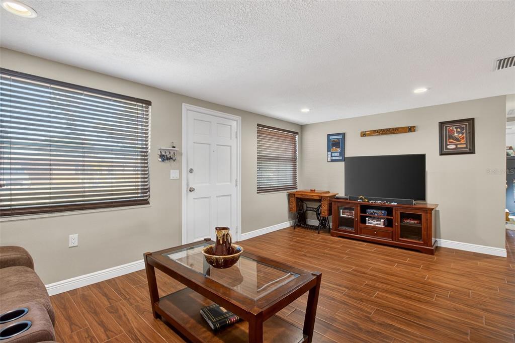 5134 Reseda Drive New Port Richey, FL 34652 - Photo 13 of 37 a living room with furniture and a flat screen tv