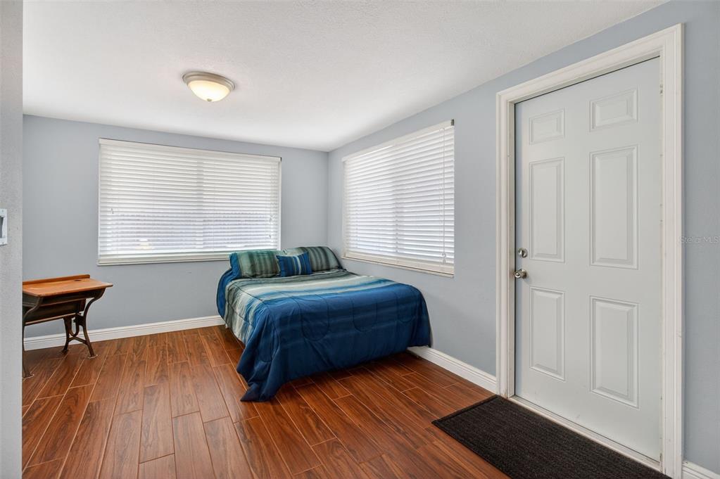 5134 Reseda Drive New Port Richey, FL 34652 - Photo 21 of 37 a bedroom with a bed and wooden floor