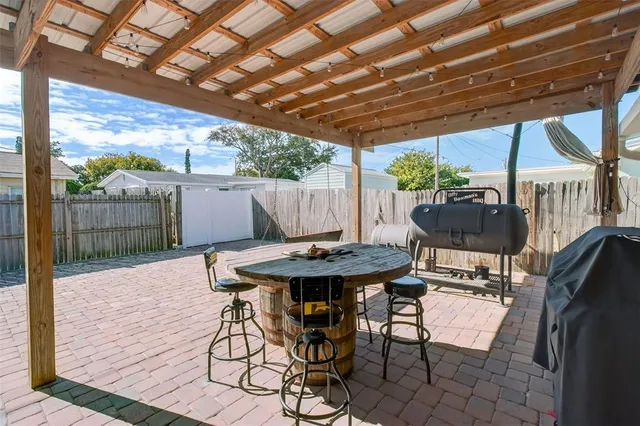 a view of patio with table and chairs and wooden floor