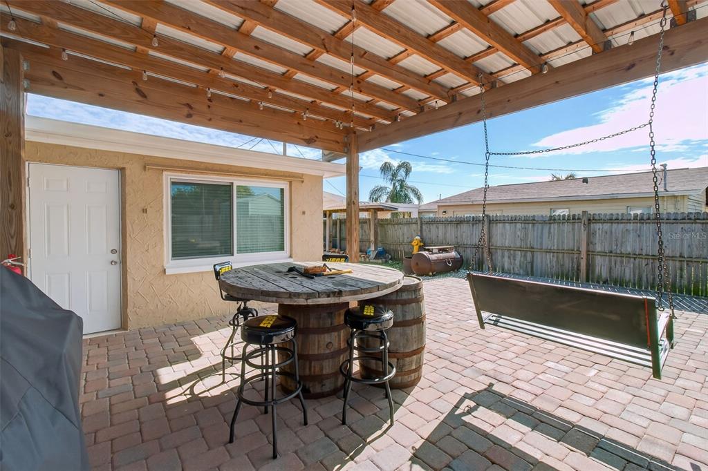 5134 Reseda Drive New Port Richey, FL 34652 - Photo 26 of 37 a view of a patio with a table and chairs and wooden floor