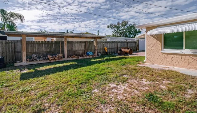 a view of a house with backyard porch and sitting area