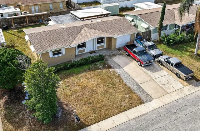 an aerial view of a house with garden space and sitting area