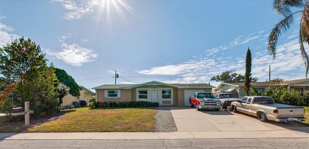 5134 Reseda Drive New Port Richey, FL 34652 - Photo 33 of 37 a front view of a house with a yard
