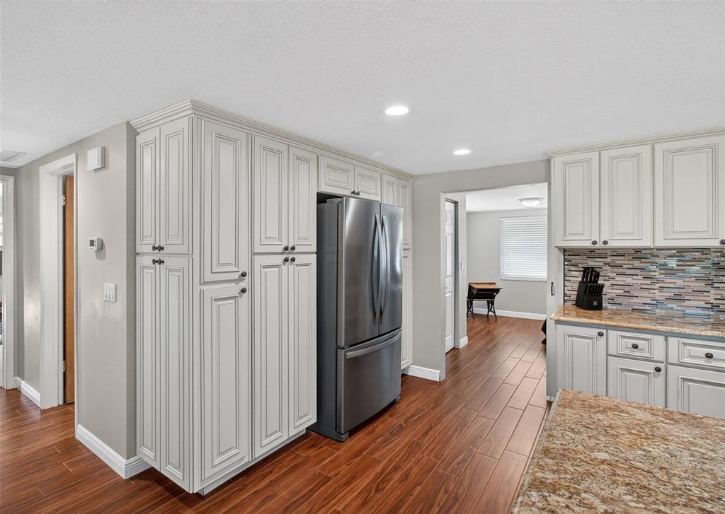 5134 Reseda Drive New Port Richey, FL 34652 - Photo 8 of 37 a kitchen with stainless steel appliances granite countertop a refrigerator and a stove top oven