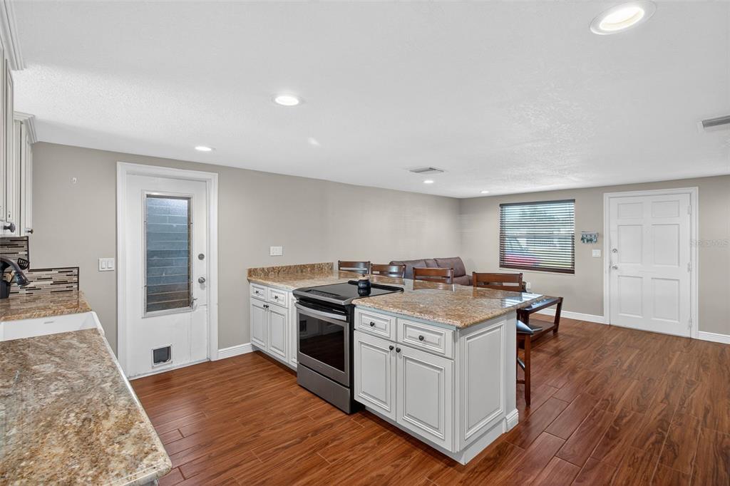 5134 Reseda Drive New Port Richey, FL 34652 - Photo 9 of 37 a kitchen with a stove and a wooden floors