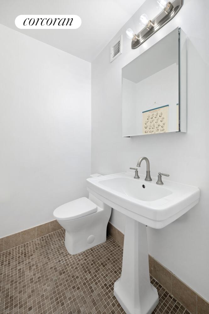 618 Washington Street, Unit GA Manhattan, NY 10014 - Photo 10 of 14 a bathroom with a sink toilet and mirror