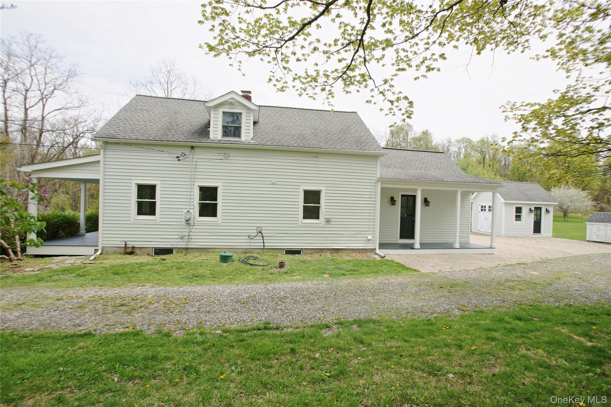 292 Mountain View Road Rhinebeck, NY 12572 - Photo 11 of 30 a front view of a house with a yard and garage
