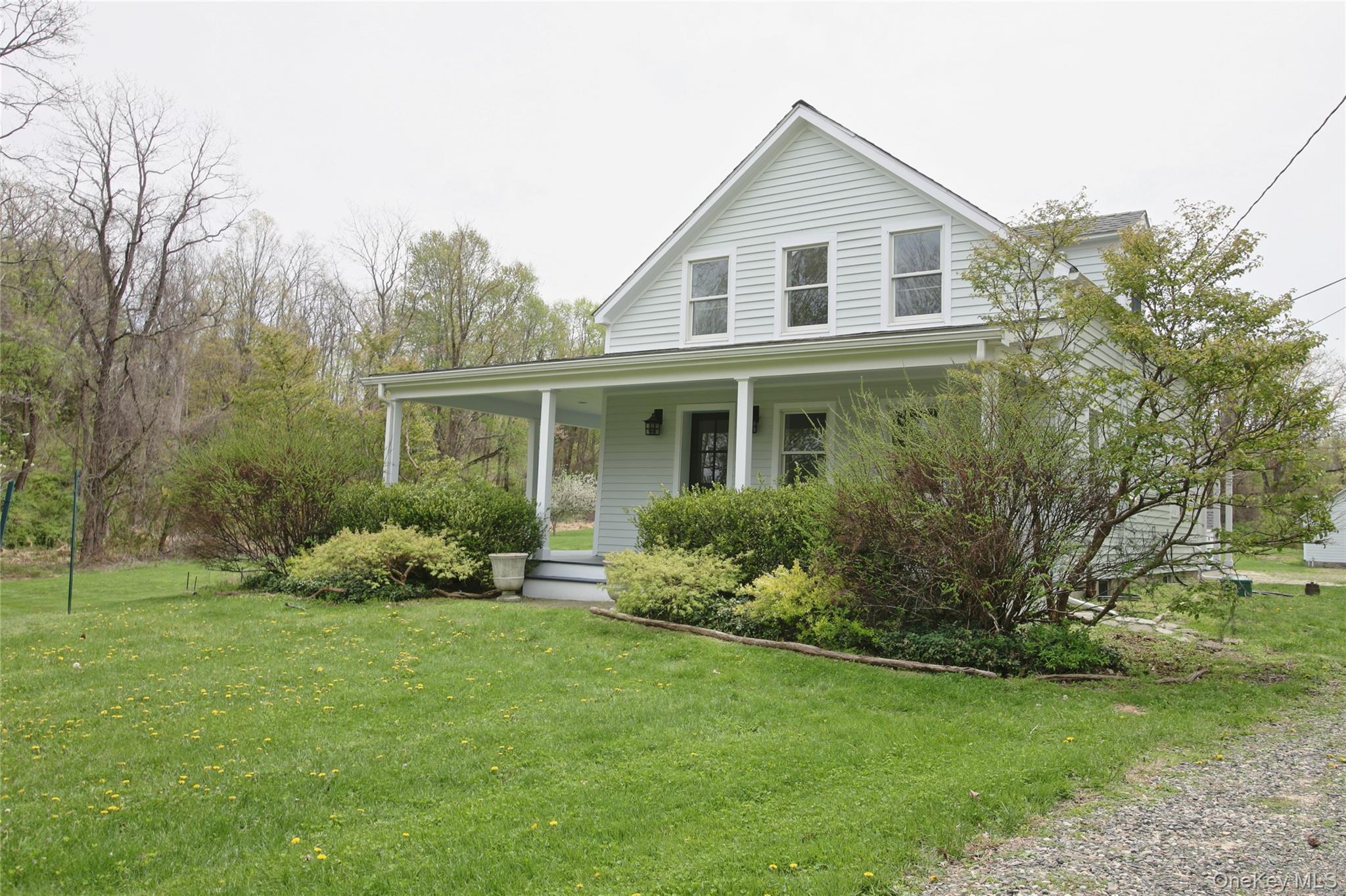 292 Mountain View Road Rhinebeck, NY 12572 - Photo 12 of 30 a front view of a house with a yard and trees
