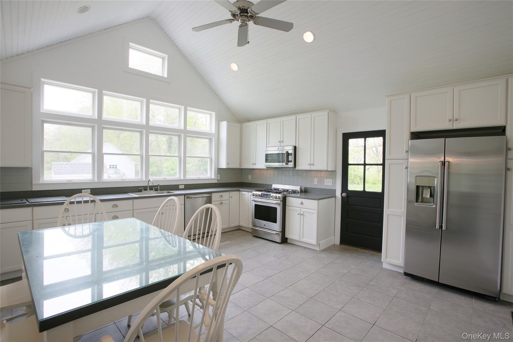 292 Mountain View Road Rhinebeck, NY 12572 - Photo 20 of 30 a kitchen with stainless steel appliances granite countertop a stove a sink a refrigerator and a microwave