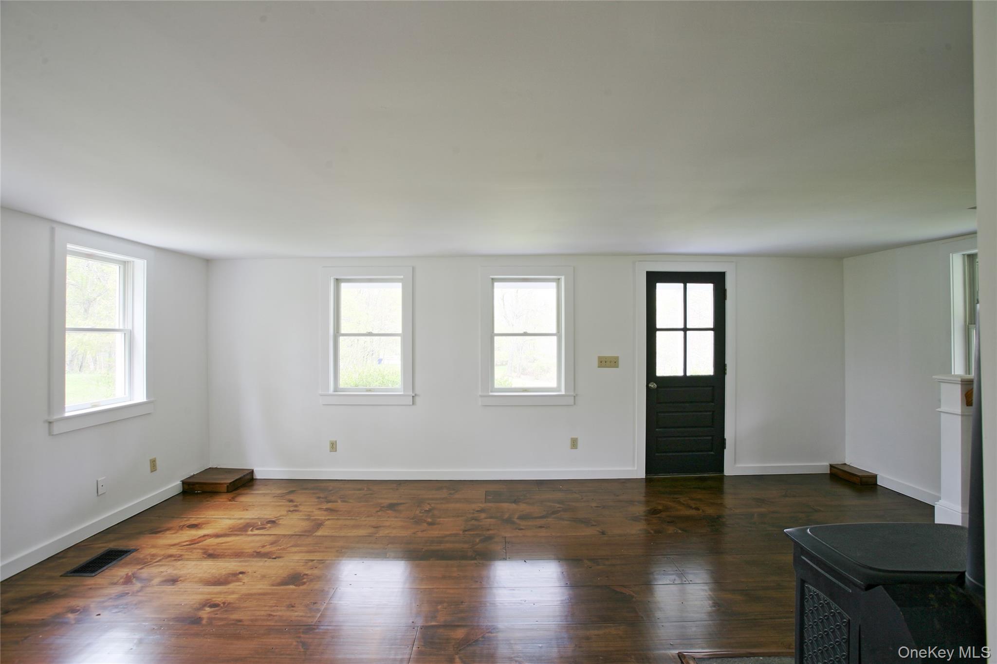 292 Mountain View Road Rhinebeck, NY 12572 - Photo 26 of 30 a view of an empty room with wooden floor and a window