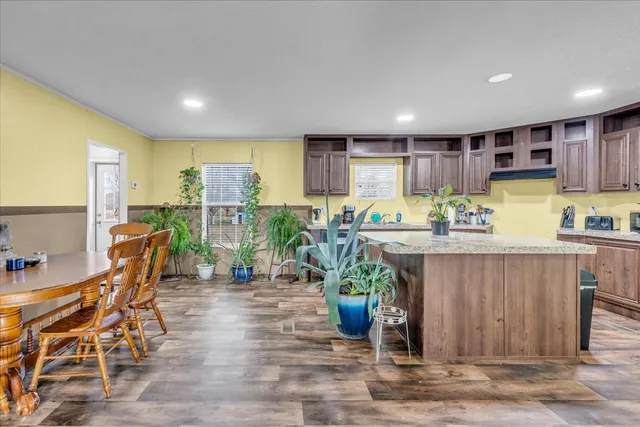 a view of kitchen with granite countertop lots of counter top space and furniture