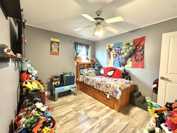 a bedroom with a bed and a chandelier