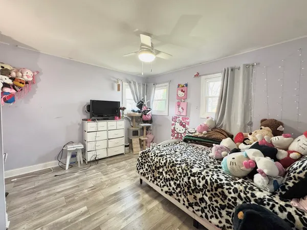 a bedroom with furniture and a flat screen tv