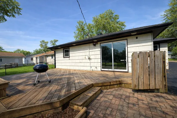 a view of a big house with a big yard and large trees
