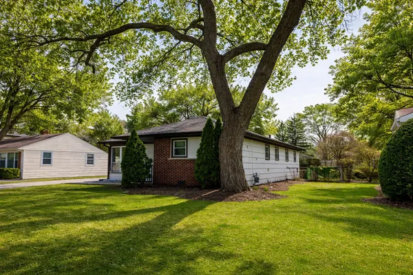 a front view of house with yard and trees
