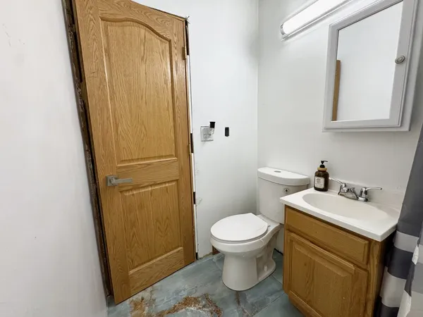 a bathroom with a sink a toilet and vanity