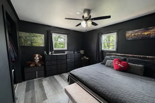 a bedroom with a bed and a flat tv screen