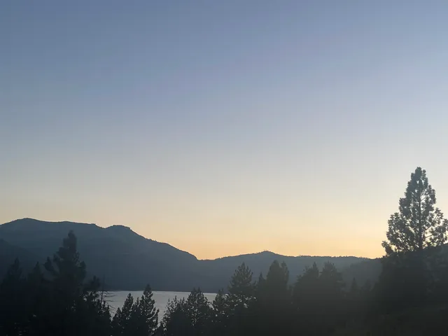 a view of mountains and a mountain in the background