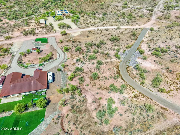 an aerial view of a house with a yard