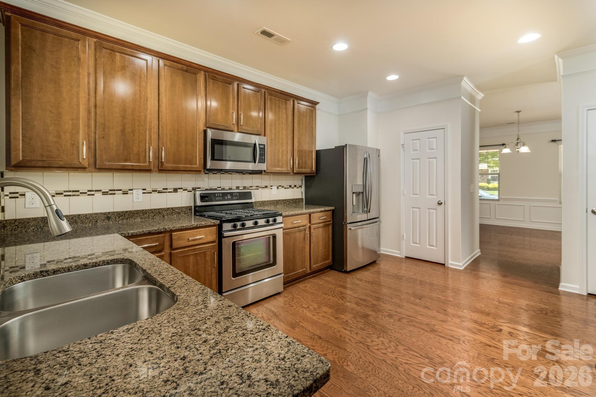 8212 Ruby Valley Road Charlotte, NC 28277 - Photo 18 of 40 a kitchen with stainless steel appliances granite countertop a refrigerator and a sink