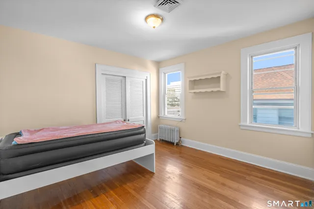 a bedroom with bed and window