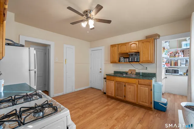 a kitchen with stainless steel appliances granite countertop a stove and a refrigerator