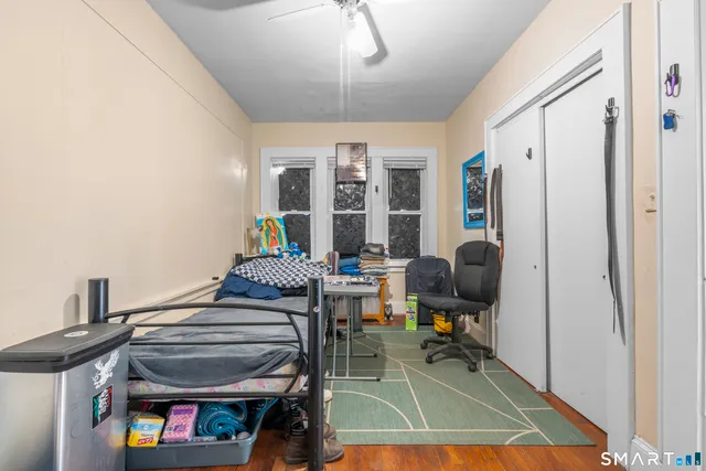 a bedroom with furniture and a window