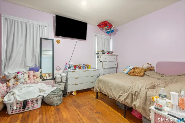 a bedroom with a bed and a flat screen tv