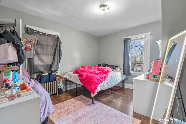a bedroom with furniture and a flat screen tv