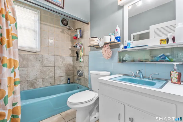 a bathroom with a sink a toilet and bathtub
