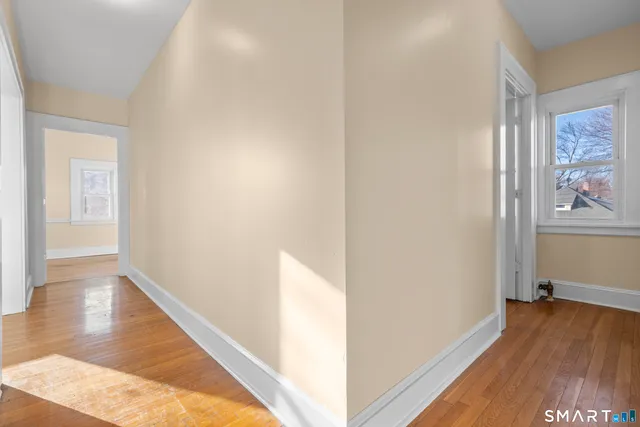 a view of hallway with wooden floor