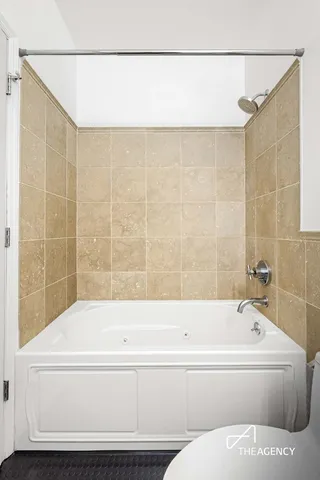a bathroom with a bathtub and shower