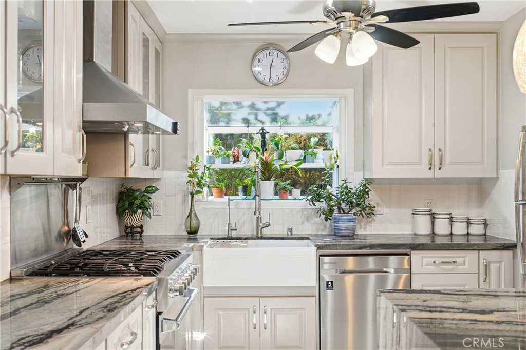 4963 Haskell Avenue Encino, CA 91436 - Photo 13 of 45 a kitchen with stainless steel appliances a white stove top oven and a refrigerator