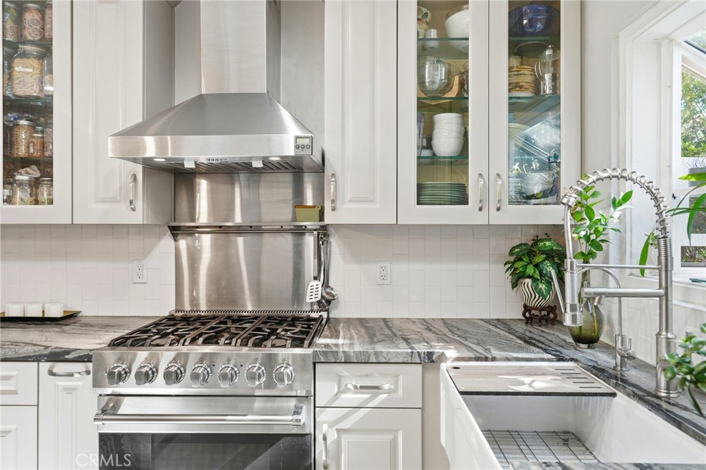 4963 Haskell Avenue Encino, CA 91436 - Photo 14 of 45 a kitchen with stainless steel appliances granite countertop a stove and a white cabinets