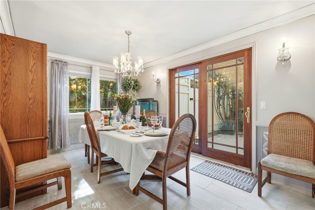 4963 Haskell Avenue Encino, CA 91436 - Photo 15 of 45 a dining room with furniture a chandelier and wooden floor