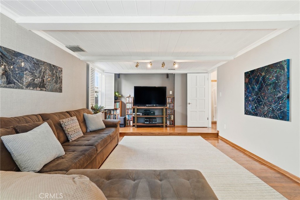 4963 Haskell Avenue Encino, CA 91436 - Photo 17 of 45 a living room with furniture and a flat screen tv