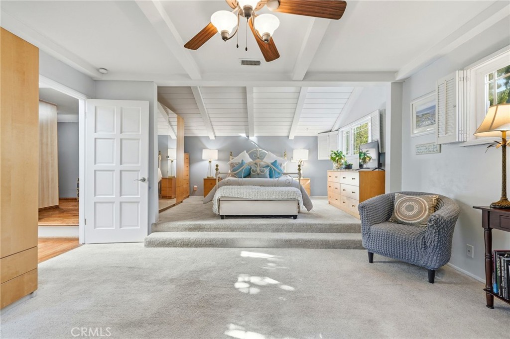 4963 Haskell Avenue Encino, CA 91436 - Photo 24 of 45 a bedroom with furniture and a chandelier