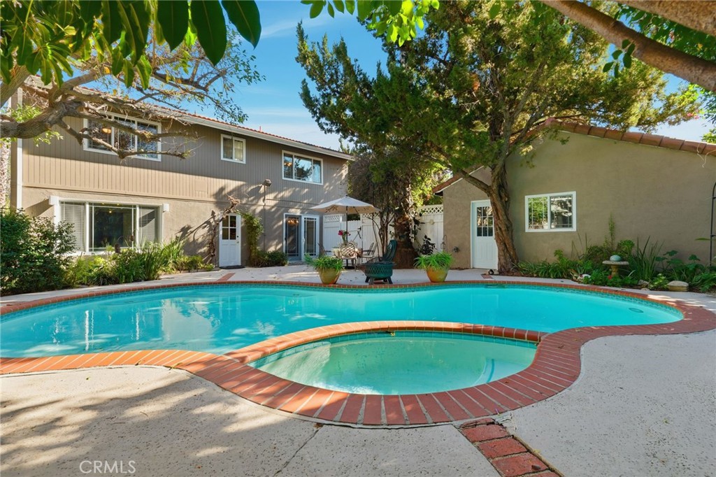4963 Haskell Avenue Encino, CA 91436 - Photo 37 of 45 a view of a house with a swimming pool and a yard