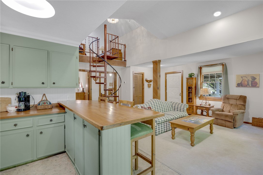 437 West Gate Road Pickens, SC 29671 - Photo 7 of 47 This open concept living space features a functional kitchen island and a charming spiral staircase.