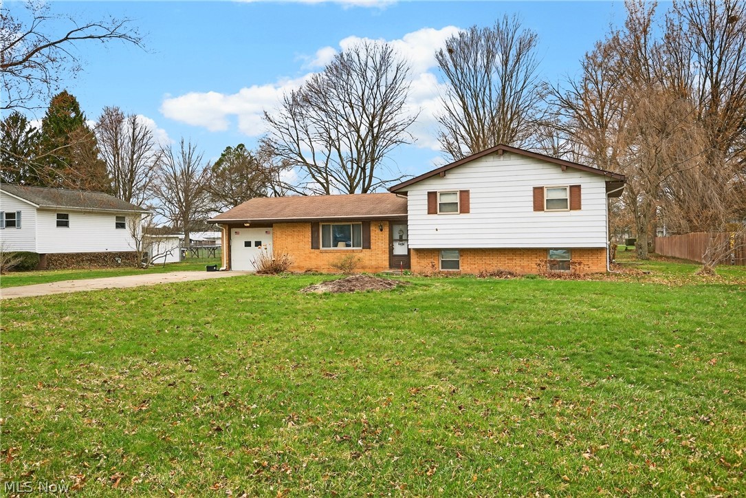 4404 Florida Street Perry, OH 44081 - Photo 3 of 24 Split level home with brick siding, a garage, and driveway