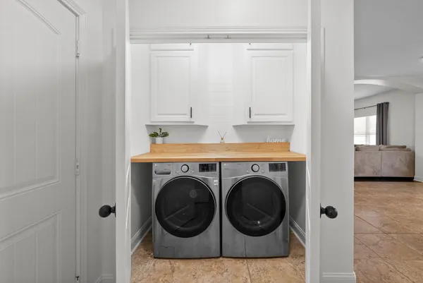 a view of a hallway with washer and dryer