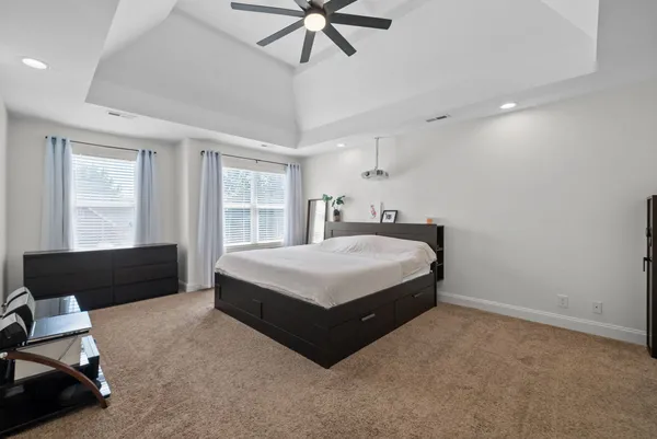a spacious bedroom with a bed and window