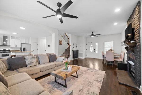 a living room with furniture or kitchen view and a wooden floor