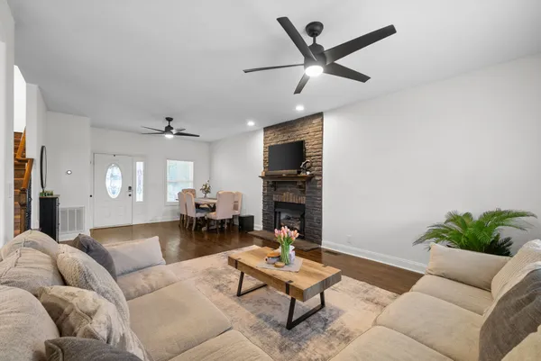 a living room with furniture and a fireplace