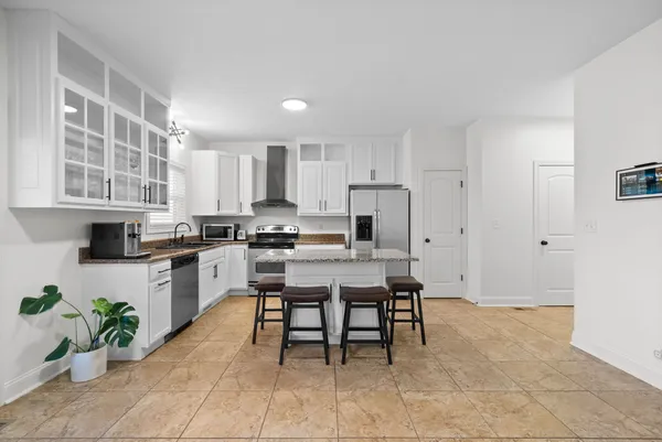 a kitchen with a table and chairs in it
