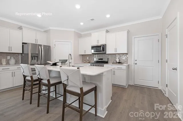 a kitchen with kitchen island a dining table and appliances