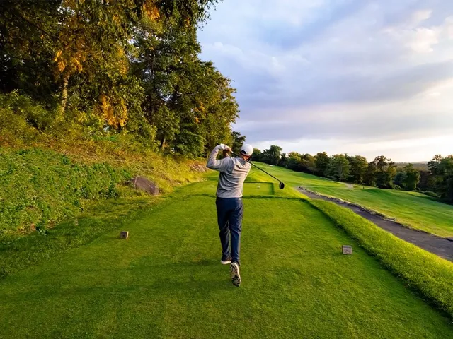 a dining room with furniture and a floor to ceiling window