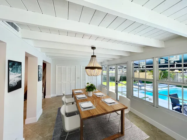 a living room with furniture a chandelier and a table