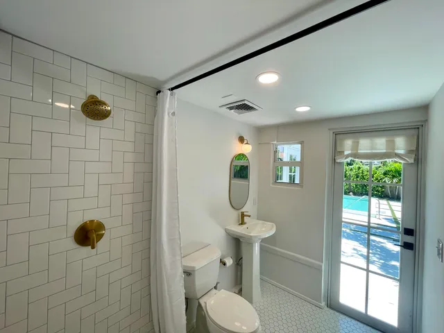 a bathroom with a sink toilet and shower