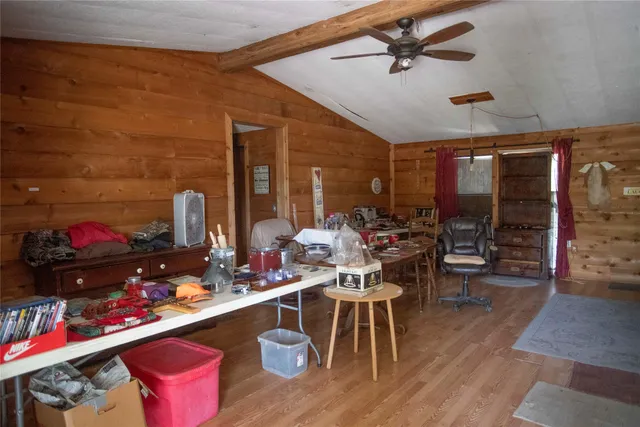 a living room with lots of furniture and a wooden floor
